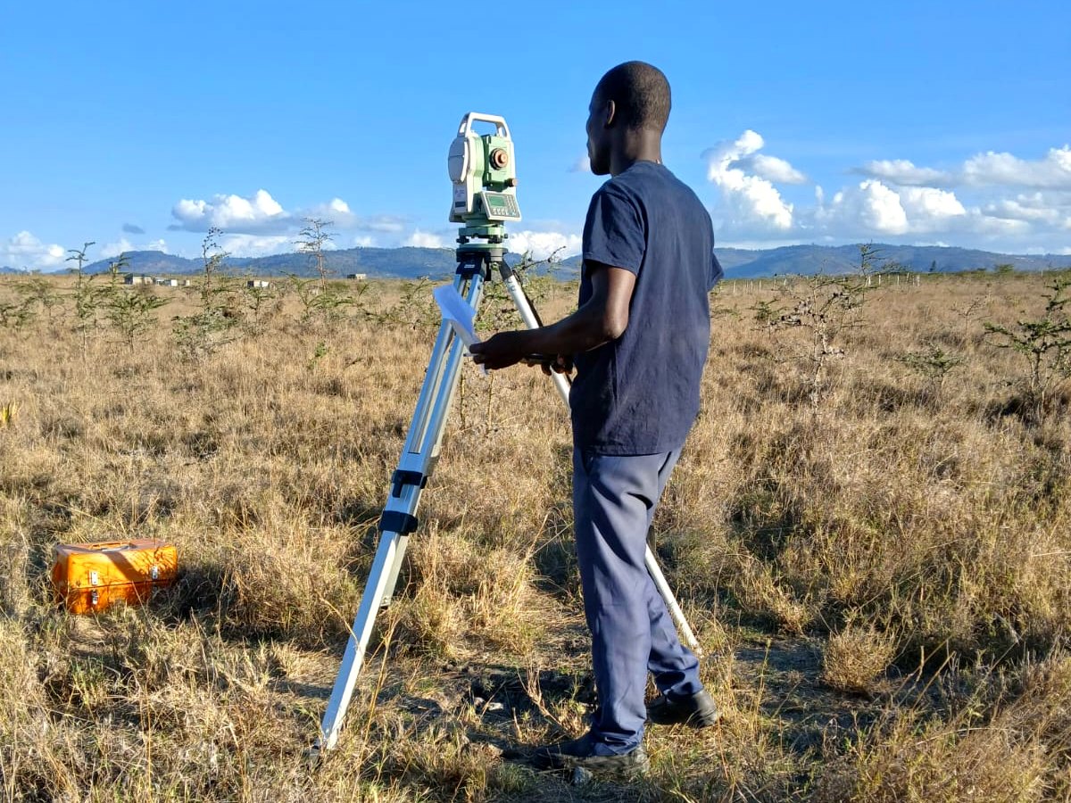 Maplas surveyor operating a total station during field surveying work in Kenya